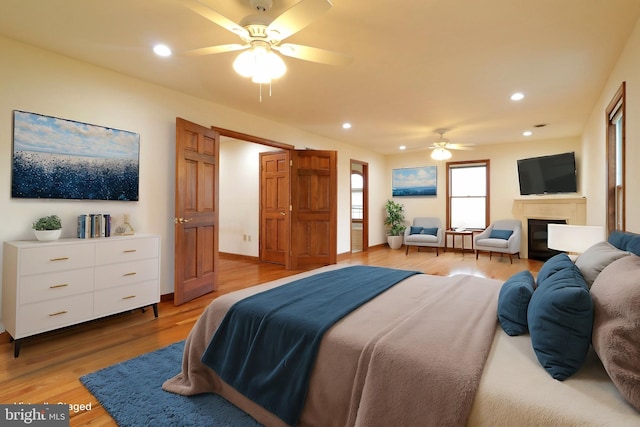 bedroom with recessed lighting, baseboards, and light wood finished floors