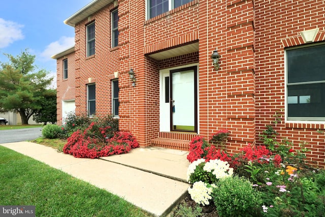 entrance to property featuring brick siding
