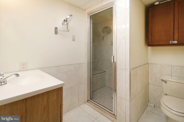 full bathroom featuring tile patterned flooring, toilet, tile walls, and a shower stall
