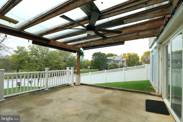view of patio with ceiling fan and fence