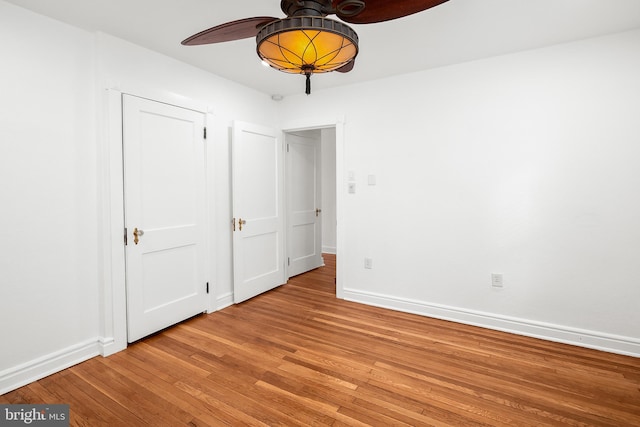 unfurnished bedroom featuring ceiling fan and light wood-type flooring