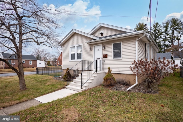 bungalow-style home featuring a front yard