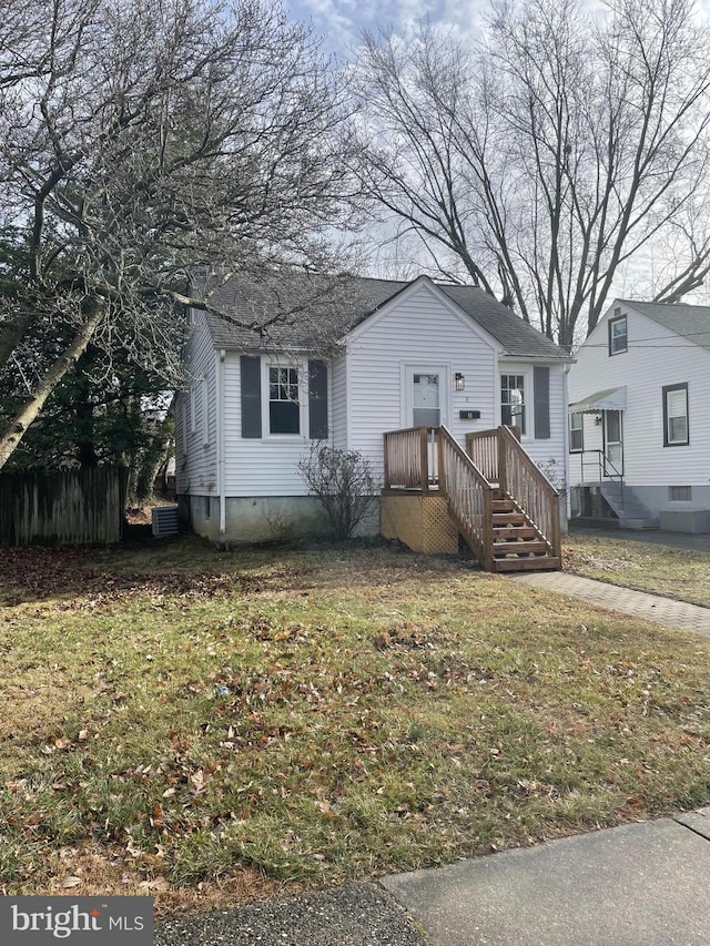 view of front of home featuring a front lawn and central air condition unit