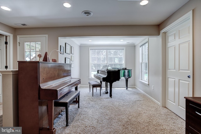 living area featuring recessed lighting, carpet flooring, visible vents, and a healthy amount of sunlight