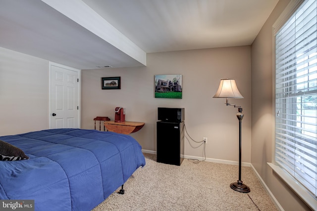 carpeted bedroom featuring visible vents and baseboards