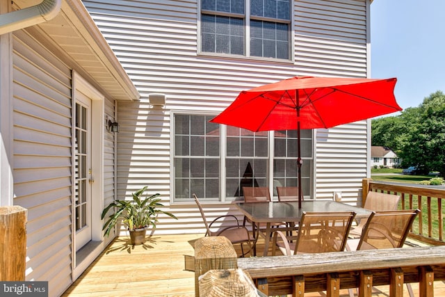 wooden terrace with outdoor dining area