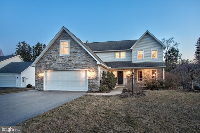 traditional home featuring stone siding, a front lawn, roof with shingles, and driveway