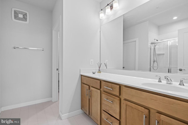 bathroom featuring vanity and a shower with shower door