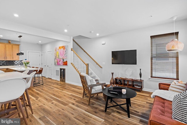 living room featuring light hardwood / wood-style floors and sink