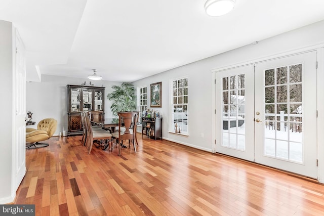 dining space with french doors and hardwood / wood-style floors