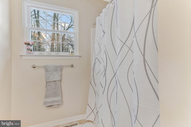 bathroom with a shower with shower curtain