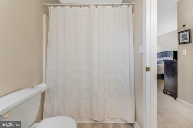 bathroom with shower / bath combo and toilet