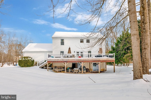 snow covered property featuring a wooden deck