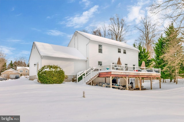 snow covered house with a deck