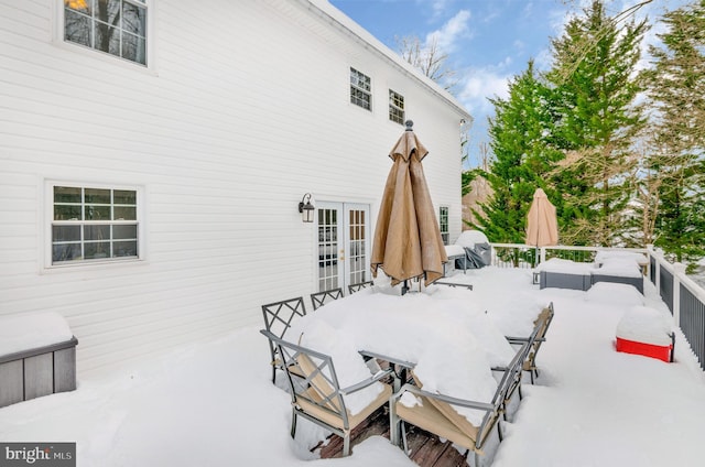 snow covered patio with french doors