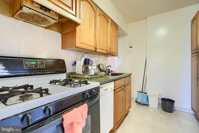 kitchen with white appliances, backsplash, and sink