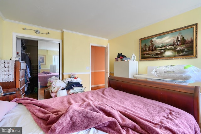 bedroom featuring a closet and crown molding