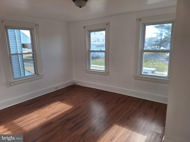 spare room featuring dark hardwood / wood-style flooring