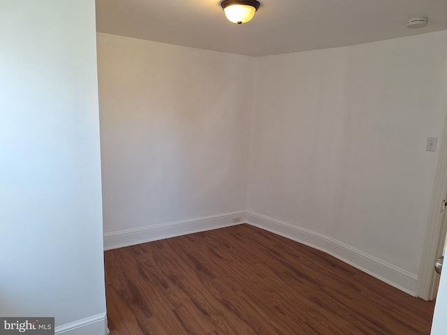 empty room with dark hardwood / wood-style floors