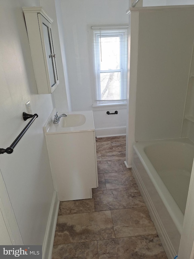 bathroom featuring washtub / shower combination and vanity