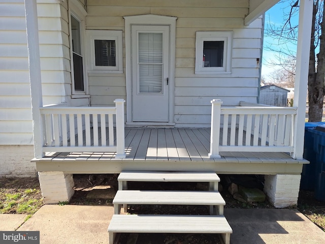 view of exterior entry with a wooden deck