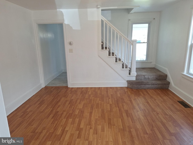 stairs with hardwood / wood-style floors