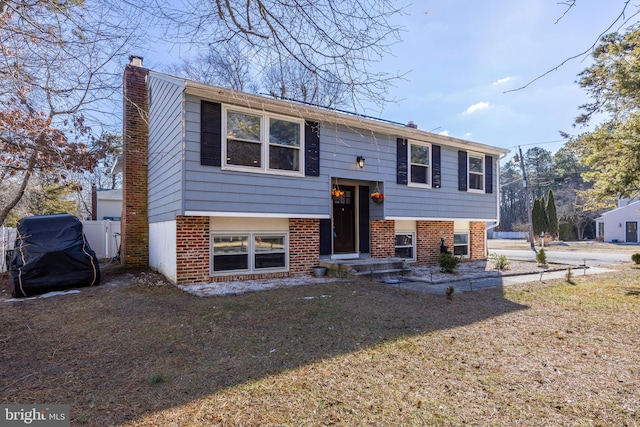 bi-level home with a front lawn