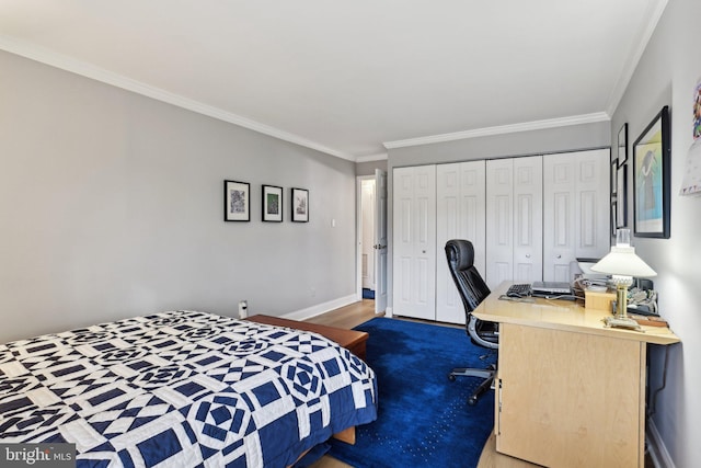 carpeted bedroom with crown molding and a closet