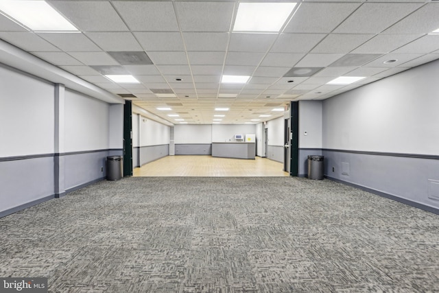 unfurnished room with a drop ceiling and light carpet