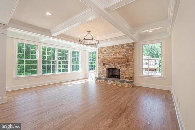 unfurnished living room with a fireplace, hardwood / wood-style flooring, a wealth of natural light, and crown molding