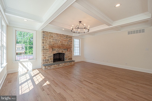 unfurnished living room with beam ceiling, wood-type flooring, a fireplace, and ornamental molding