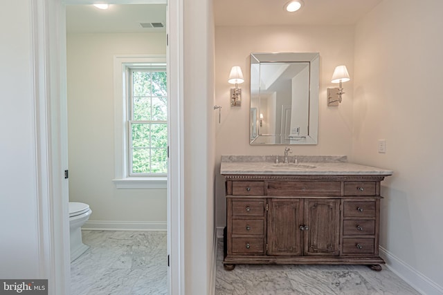 bathroom with vanity and toilet