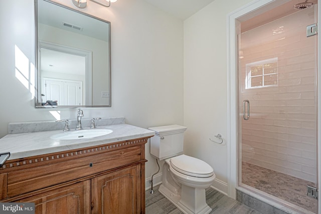 bathroom with a shower with shower door, toilet, wood-type flooring, and vanity