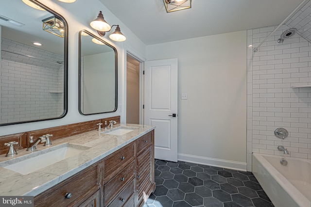 bathroom featuring tile patterned floors, vanity, and tiled shower / bath combo