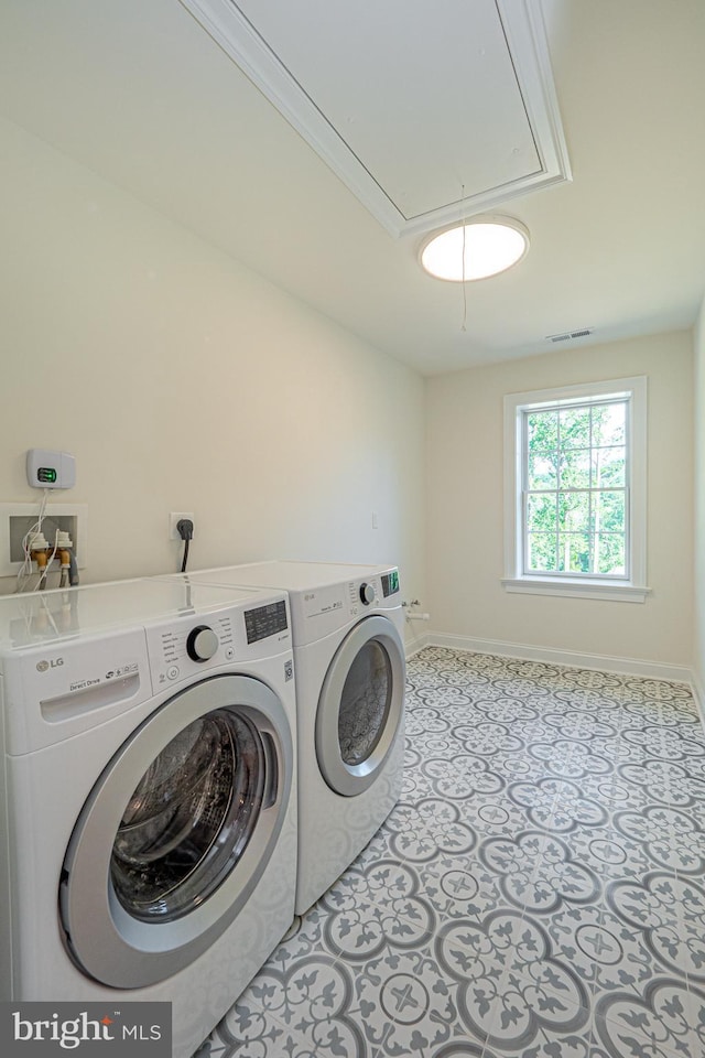 laundry area featuring washer and dryer and ornamental molding