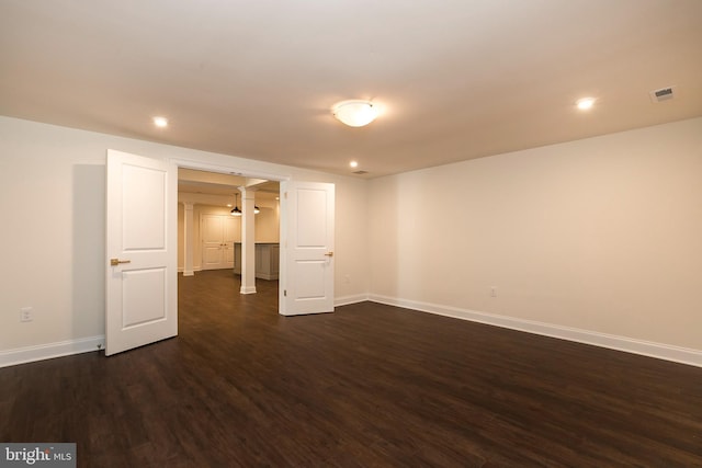 spare room featuring dark wood-type flooring