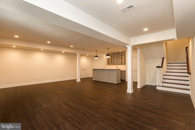 unfurnished living room with dark hardwood / wood-style flooring