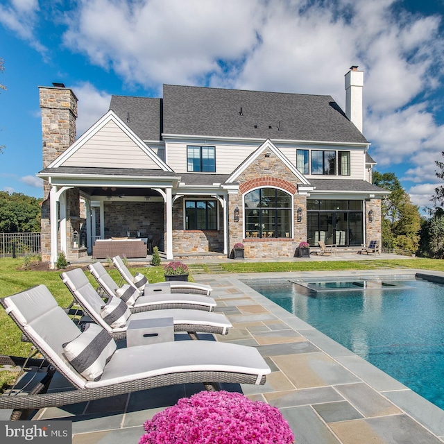 rear view of house featuring outdoor lounge area and a patio area