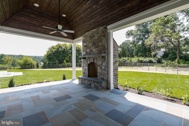 view of patio / terrace featuring an outdoor stone fireplace and ceiling fan