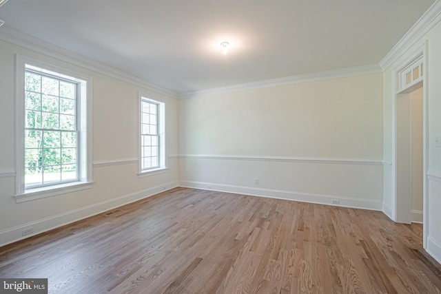 unfurnished room with light wood-type flooring, plenty of natural light, and ornamental molding