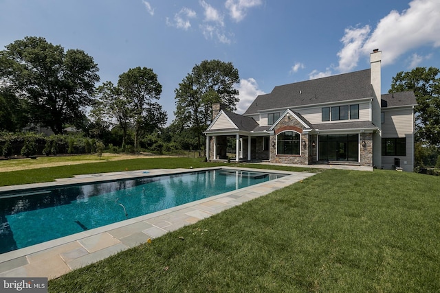 view of swimming pool with a lawn