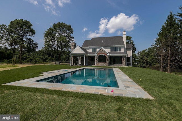 view of swimming pool featuring a lawn and a patio