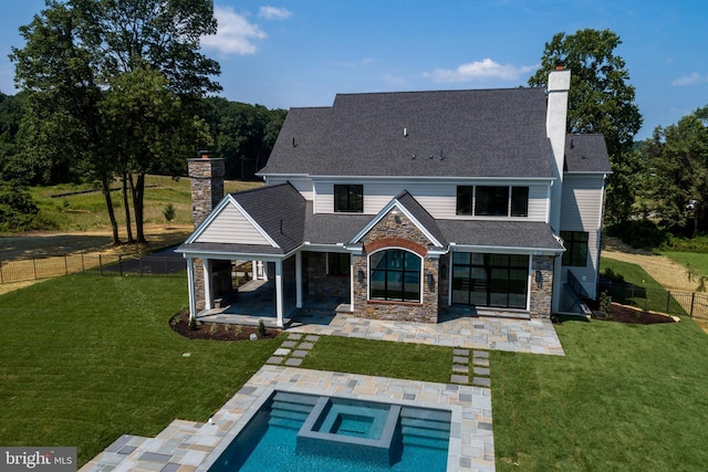 back of property featuring a yard and a patio area