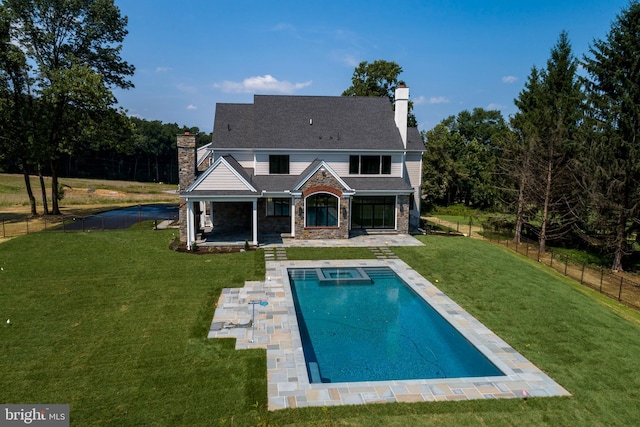 rear view of property with a lawn and a patio area