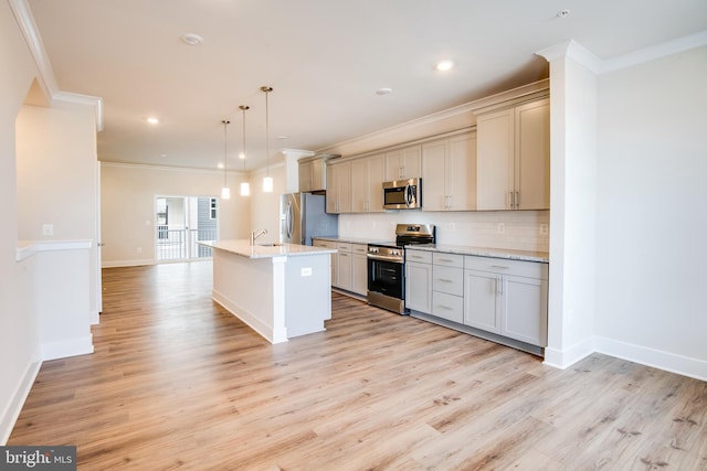 kitchen featuring hanging light fixtures, tasteful backsplash, light stone counters, a center island with sink, and appliances with stainless steel finishes