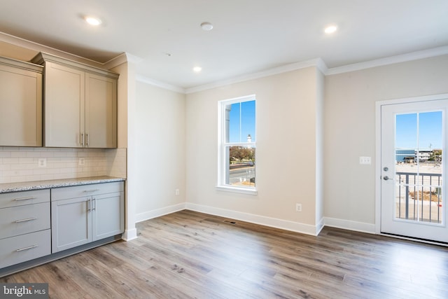 interior space with crown molding and light wood-type flooring