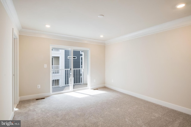 unfurnished room featuring ornamental molding and light carpet