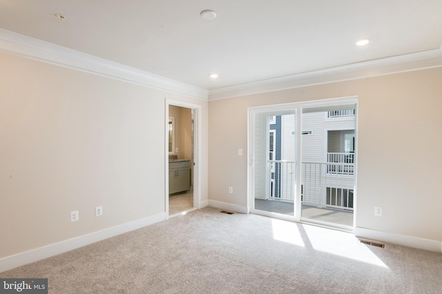 unfurnished room featuring light carpet and ornamental molding