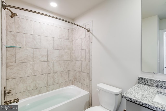 full bathroom with vanity, toilet, and tiled shower / bath