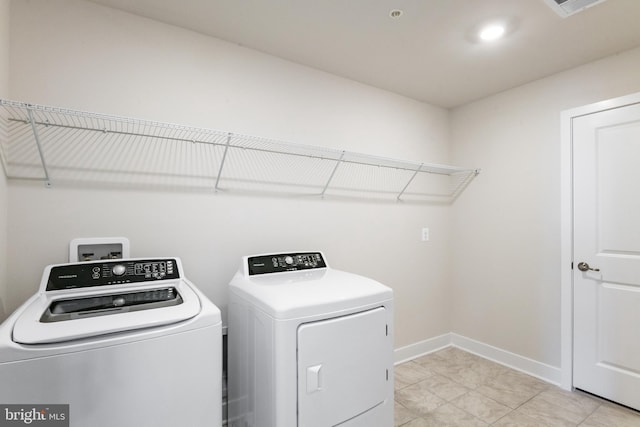 laundry room with light tile patterned flooring and independent washer and dryer